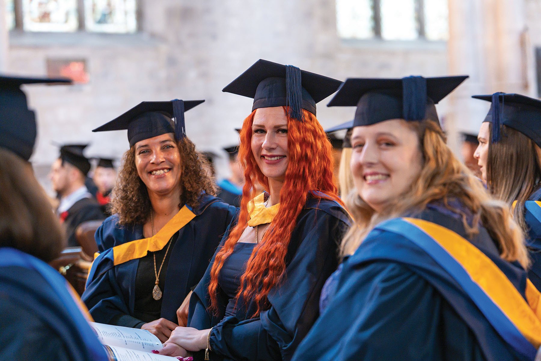 3 girls in graduation gowns
